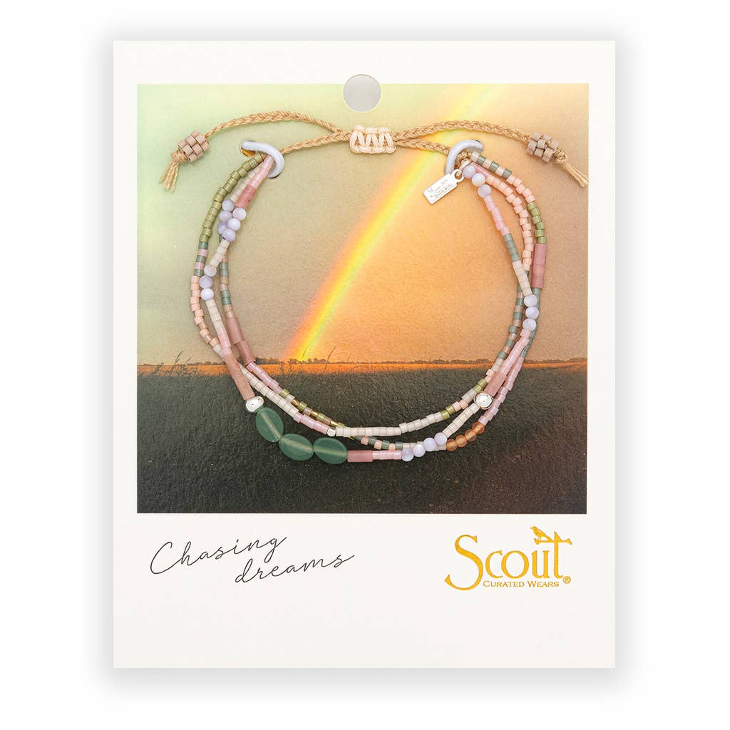 Bracelet with multiple strands of beads on a card with a rainbow over water and 'Scout' brand logo.