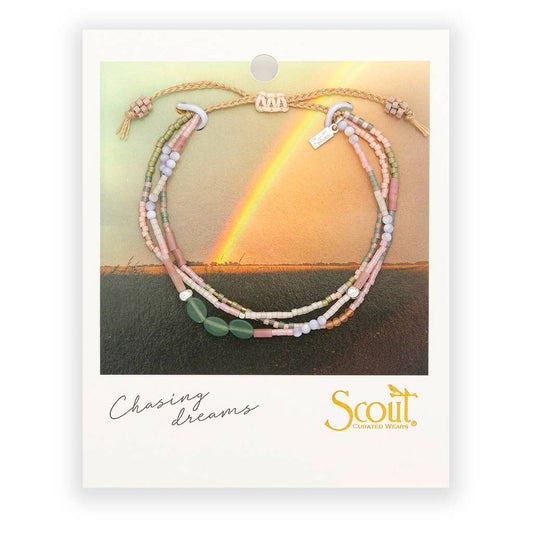 Bracelet with multiple strands of beads on a card with a rainbow over water and 'Scout' brand logo.