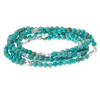 Convertible beaded necklace/wrap bracelet with silver accents on a white background