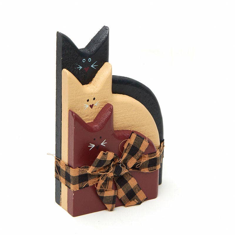 Decorative wooden cats with a plaid ribbon on a white background