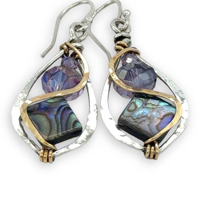 Pair of earrings with purple gemstones and gold accents on a white background