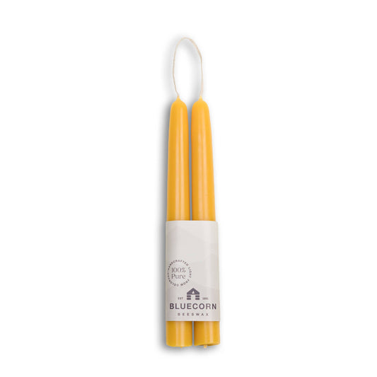 Beeswax taper candles in  white packaging with Bluecorn branding on a white background