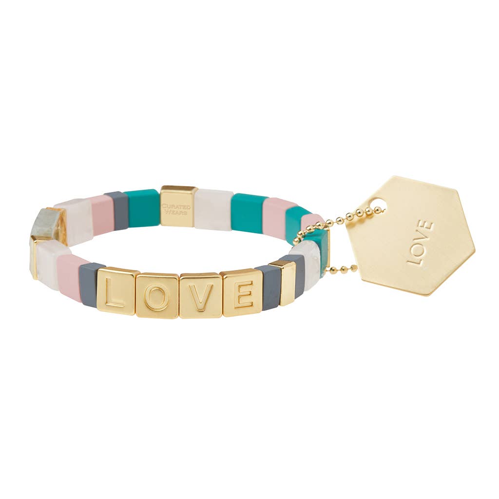 Colorful bracelet with 'LOVE' tag on a white background