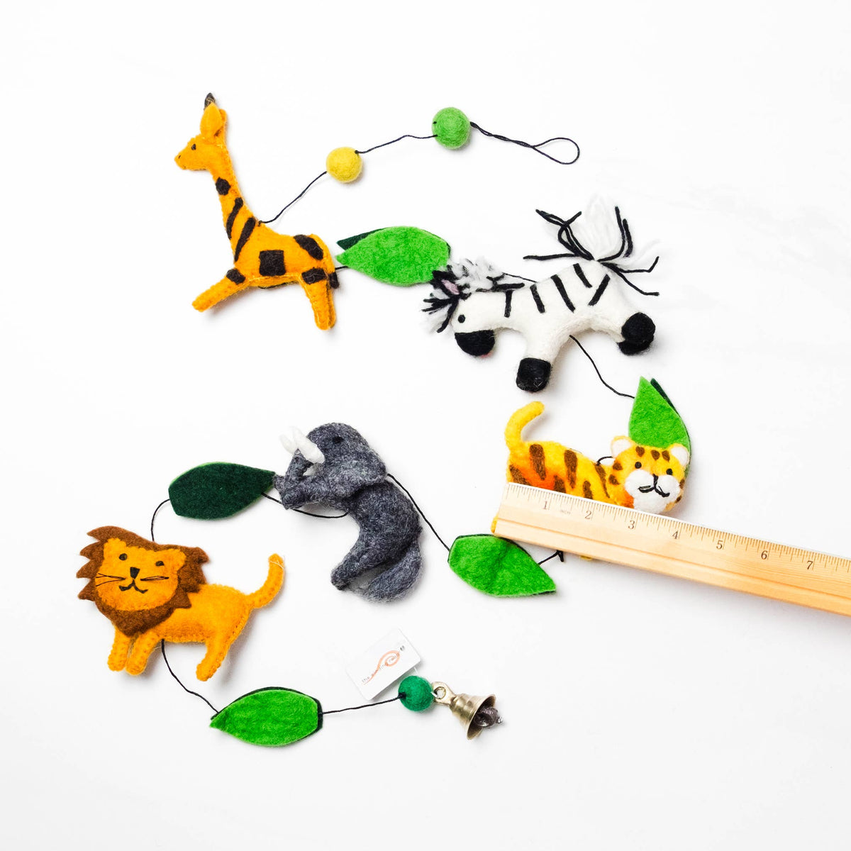 Garland with felt animal figures on a white background with a ruler for scale.