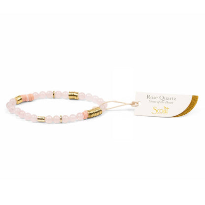 Rose Quartz bracelet with gold accents on a white background