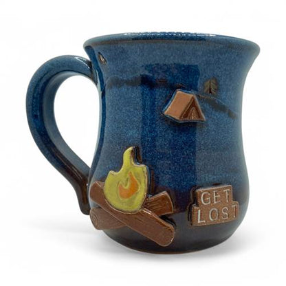 Blue ceramic mug with camping-themed decorations on a white background