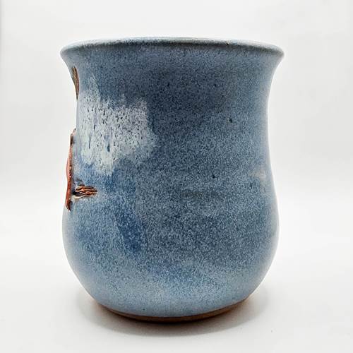 Blue ceramic mug with speckled texture on a white background