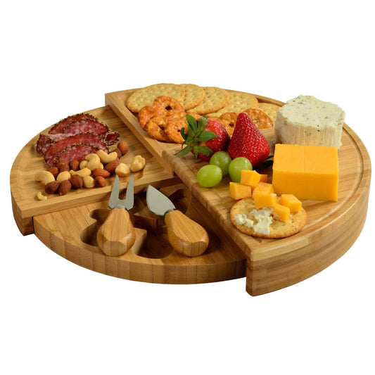 Wooden charcuterie board with meats, cheeses, and fruits on a white background