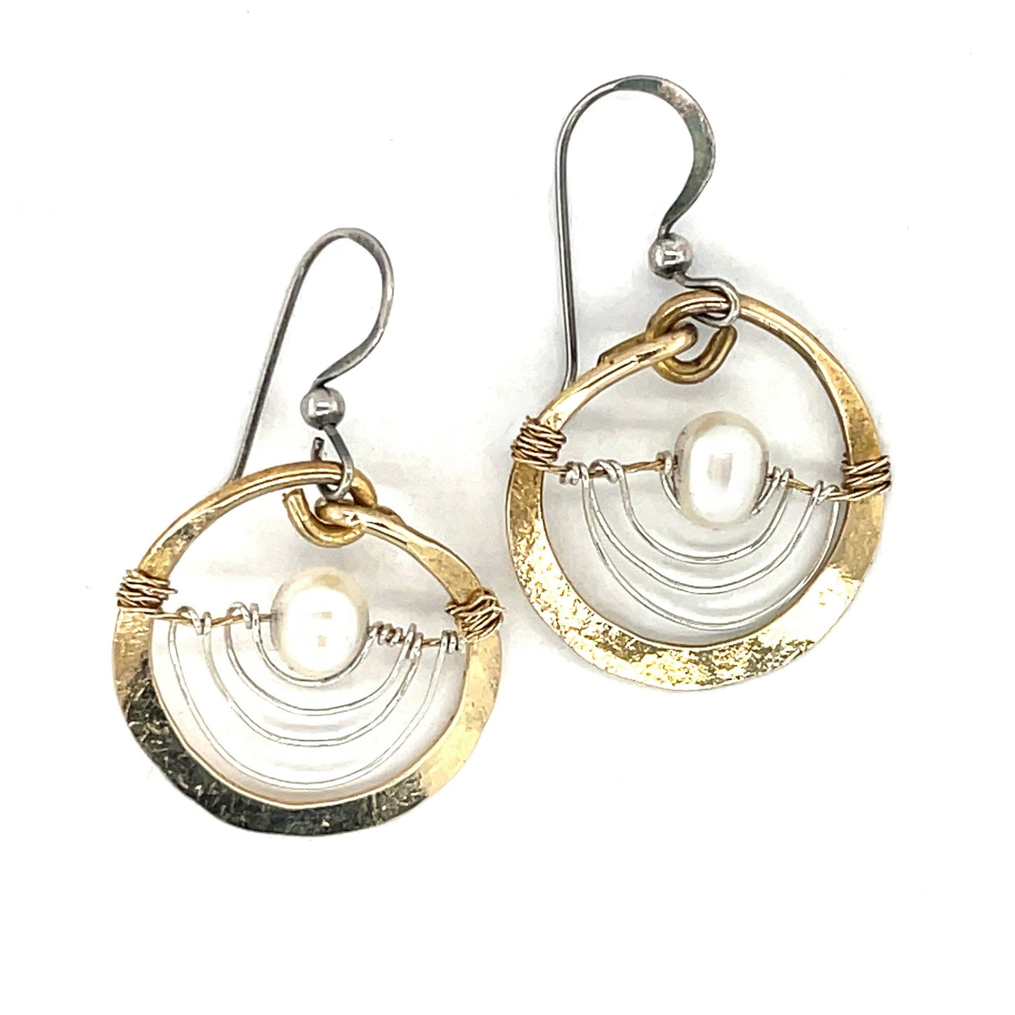Pair of gold and silver circular earrings on a white background