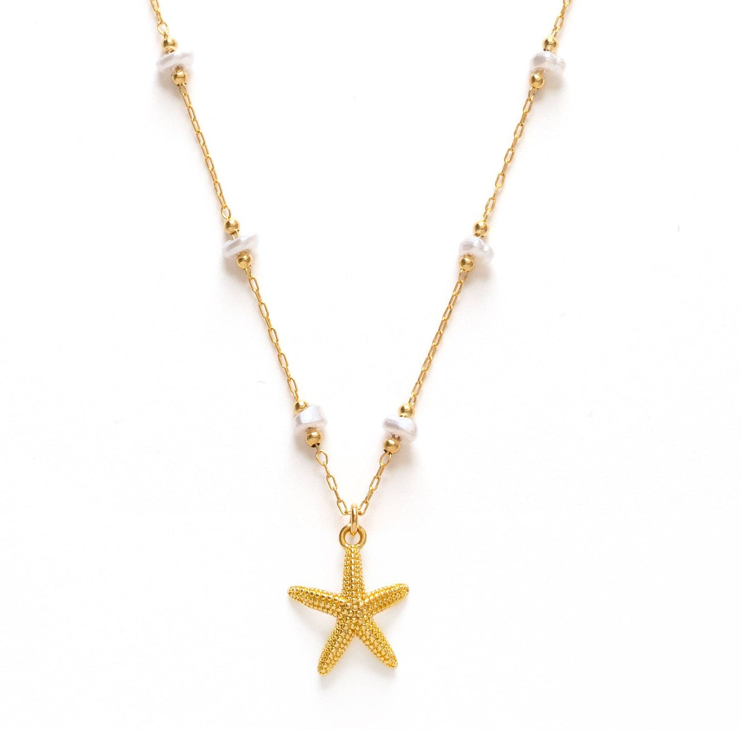 Gold starfish pendant necklace on a white background