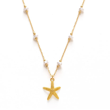 Gold starfish pendant necklace on a white background