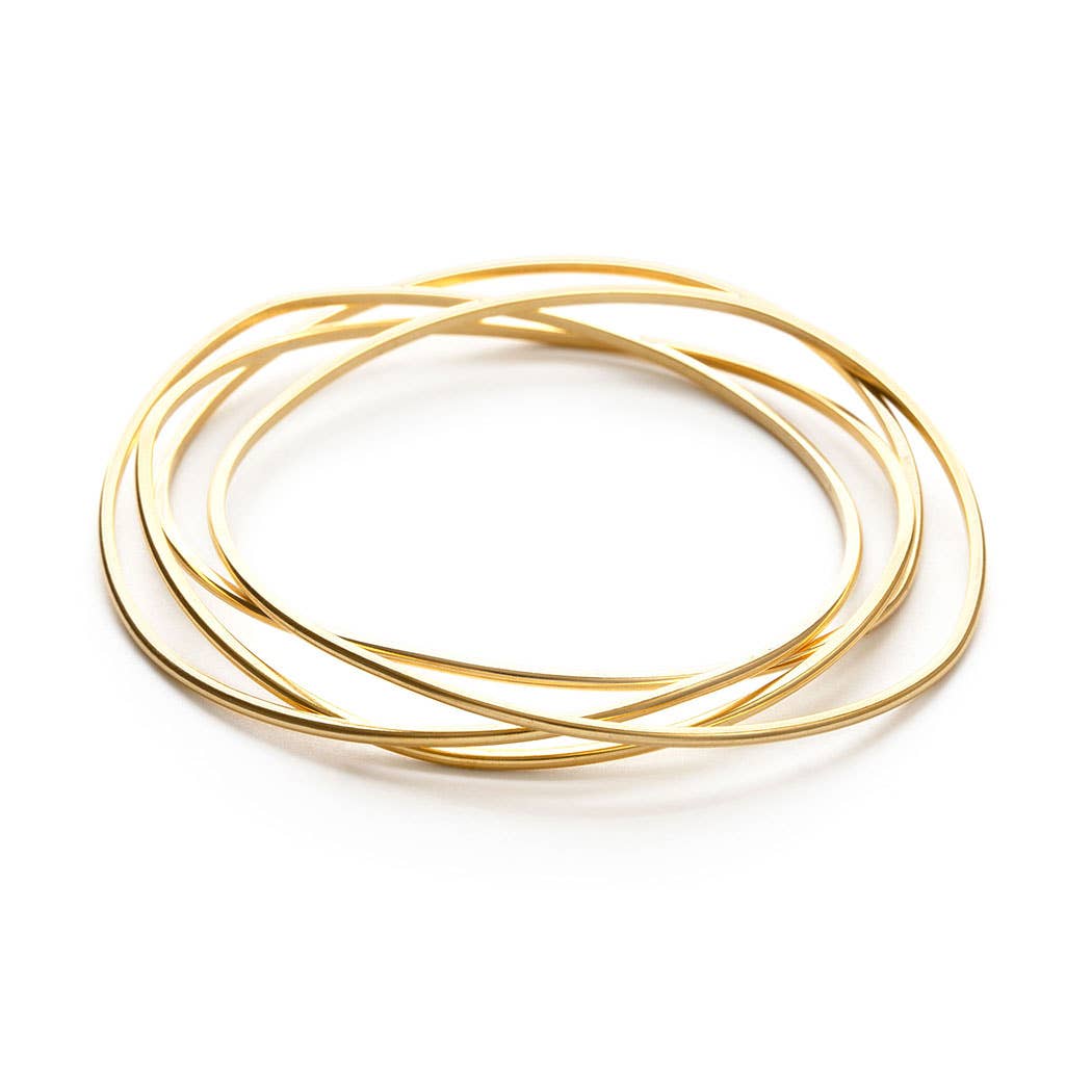 Set of gold bangles on a white background