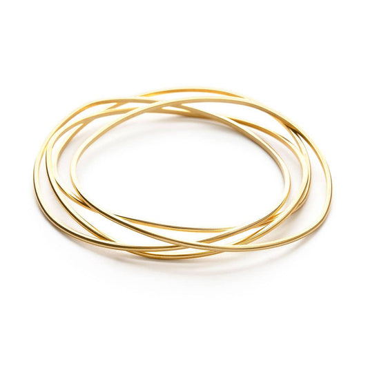 Set of gold bangles on a white background