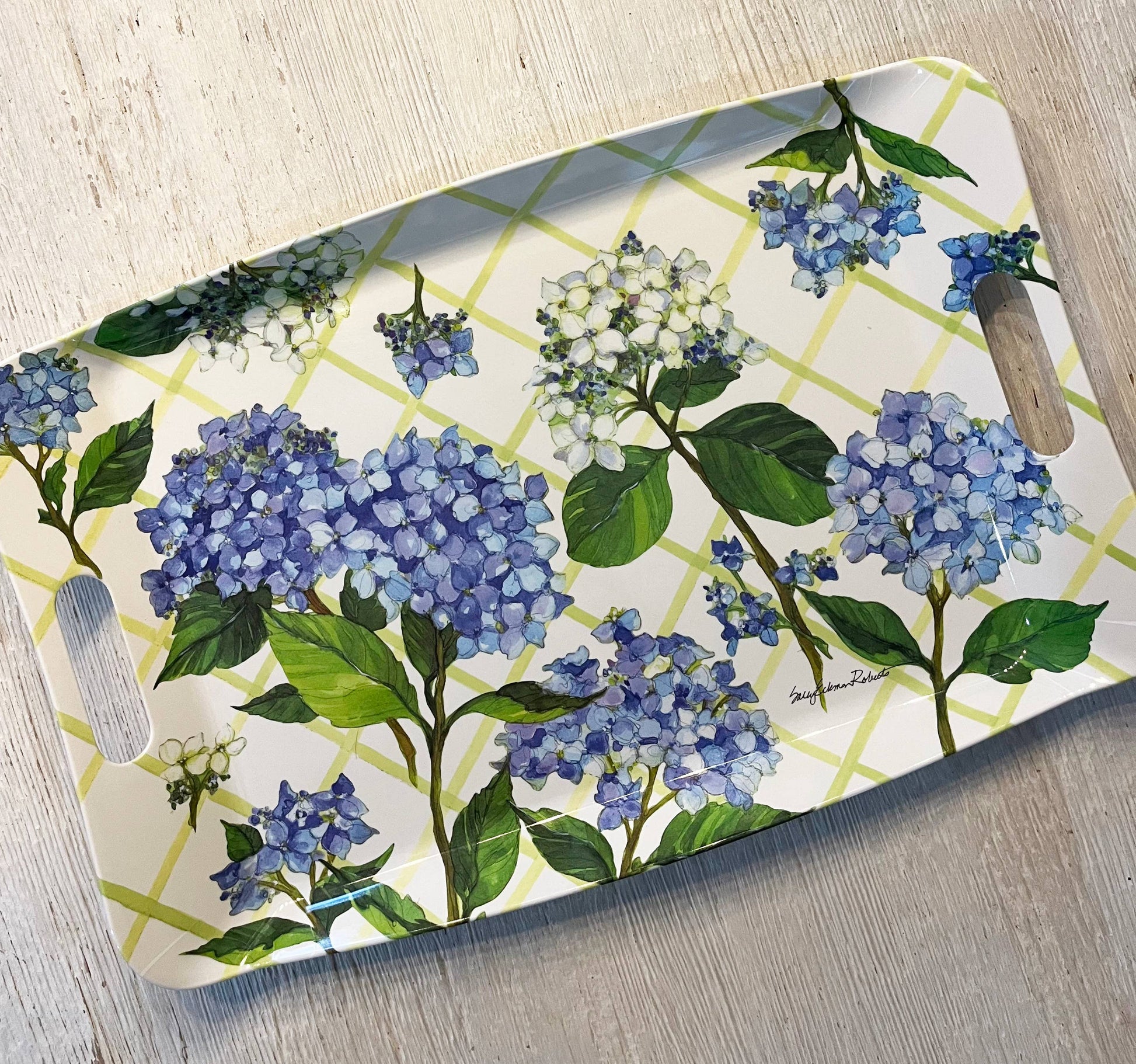 Serving tray with blue floral design on a wooden surface