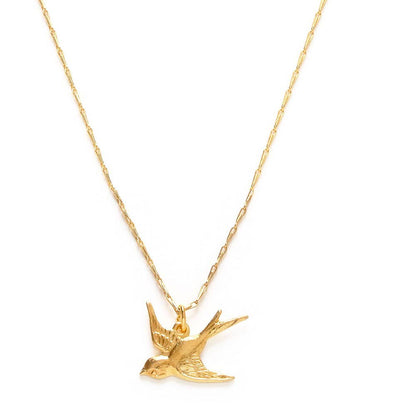 Gold bird-shaped pendant on a chain against a white background