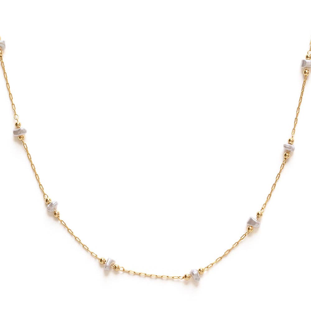 Gold necklace with small pearls on a white background