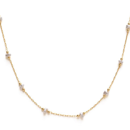 Gold necklace with small pearls on a white background