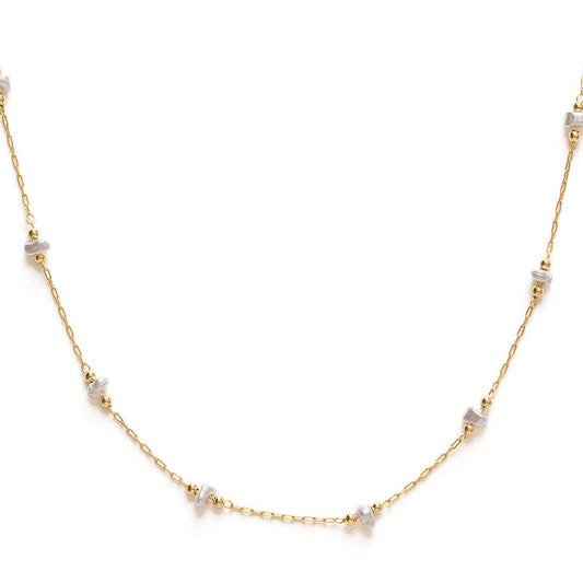 Gold necklace with small pearls on a white background