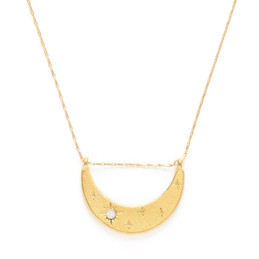 Gold necklace with a half-moon pendant on a white background