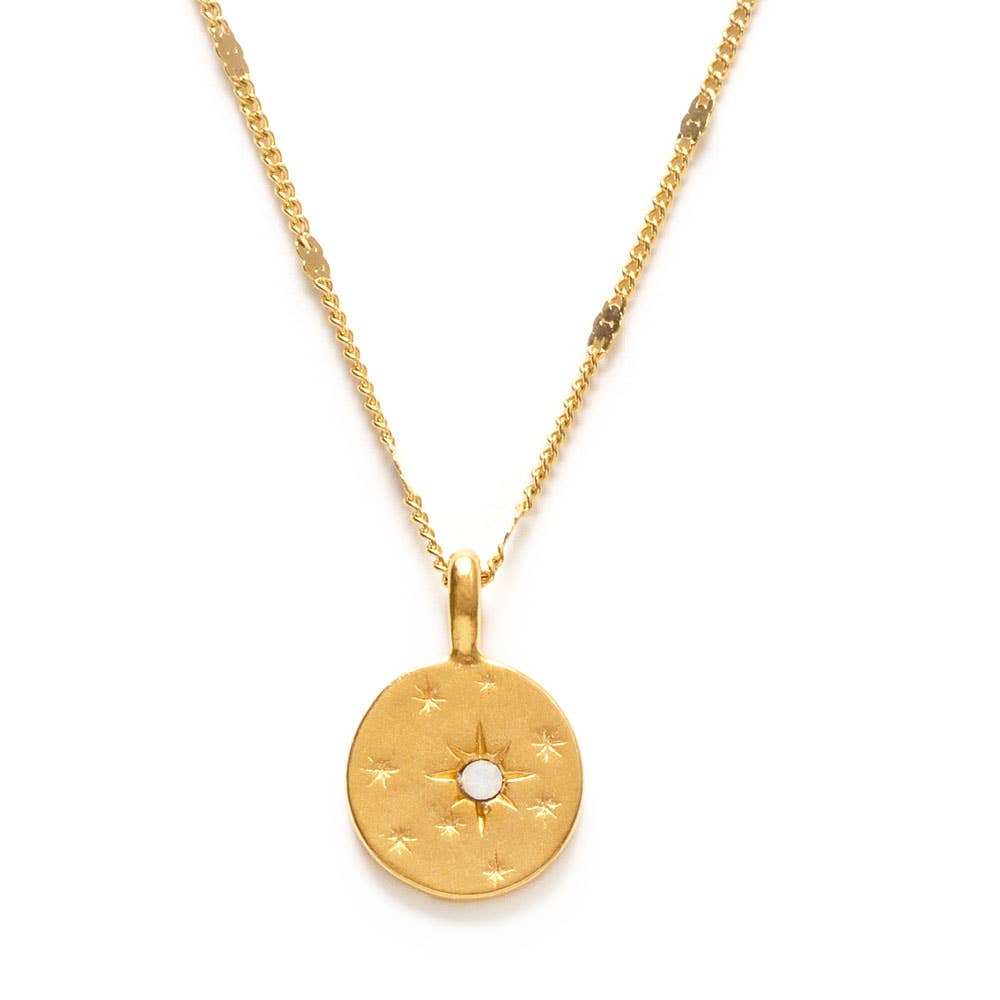 Gold necklace with a round pendant on a white background
