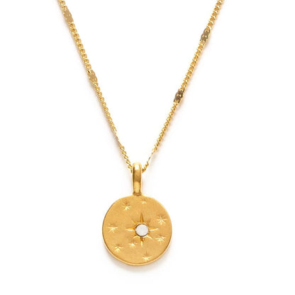 Gold necklace with a round pendant on a white background