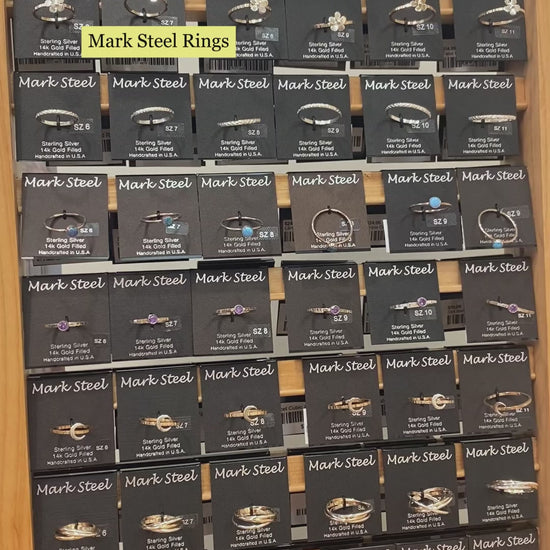 Video of Mark Steel Jewelry rings on display with closeups showcasing various rings. 