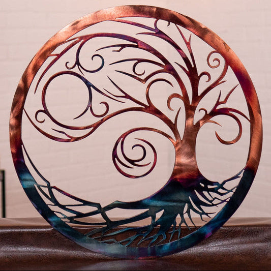 Decorative metal wall art with tree of life design on a neutral background