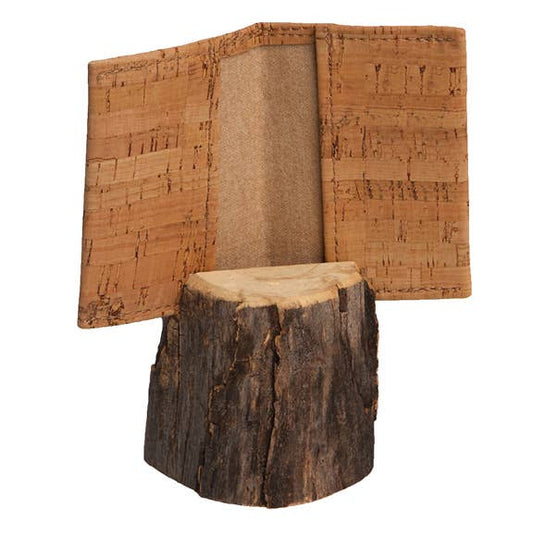 Small bifold cork wallet held open by a wooden stand on a white background.