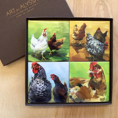 A set of four ceramic tile coasters with various images of chickens, presented in a gift box with 'Art by Alyssa' branding.