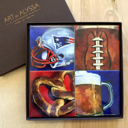 A set of four ceramic tile coasters with cork backing, each featuring a different image related to the New England Patriots, packaged in a gift box with 'Art by Alyssa' branding.
