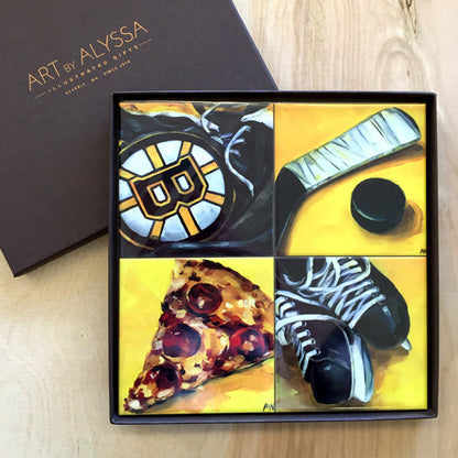A set of four ceramic tile coasters with cork backing, displayed in a box with a 'Art by Alyssa' logo, featuring images inspired by Boston Bruins.