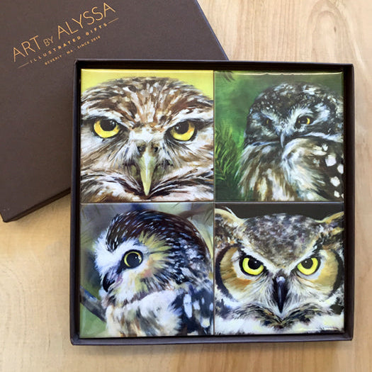 A set of four ceramic tile coasters with owl images, displayed in a gift box with 'Art by Alyssa' branding.