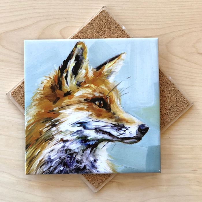 A square trivet with a cork backing featuring an artistic depiction of a fox's head in profile.