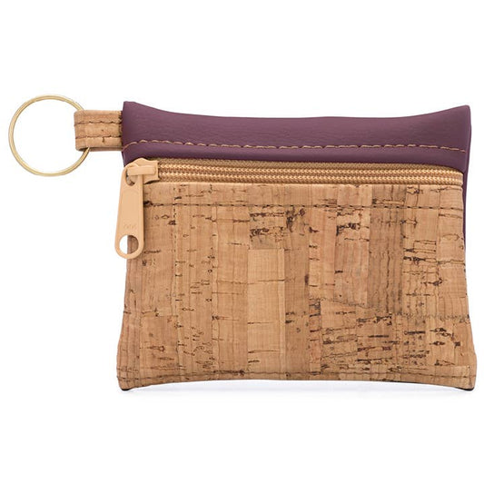 A small burgundy and cork key chain pouch with a zipper closure, a gold key ring, and made from cork fabric and faux leather.